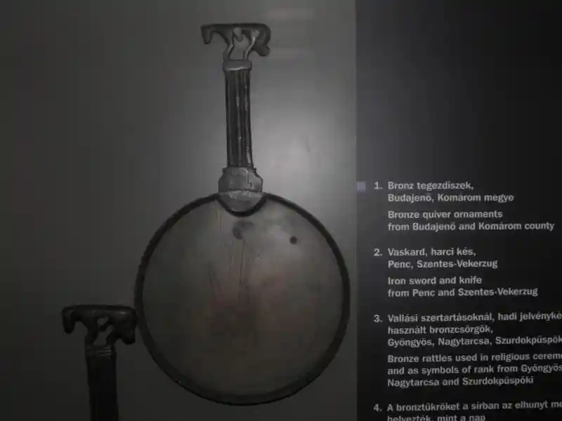 Bronze mirror, a solar symbol with an animal on the handle